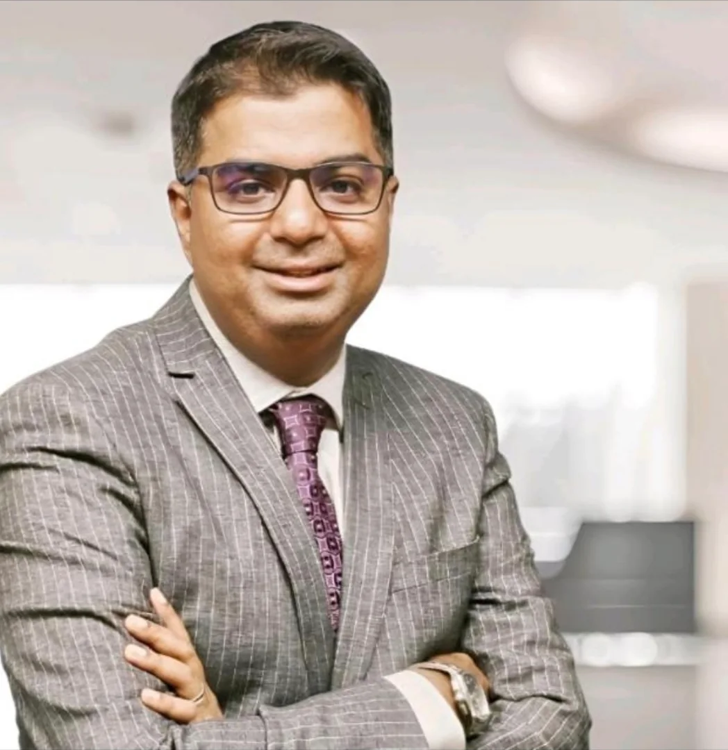 Rakesh K, co-founder of Finbharat, in a grey pinstripe suit